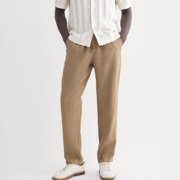 Man wearing linen pants with short-sleeved shirt and casual shoes