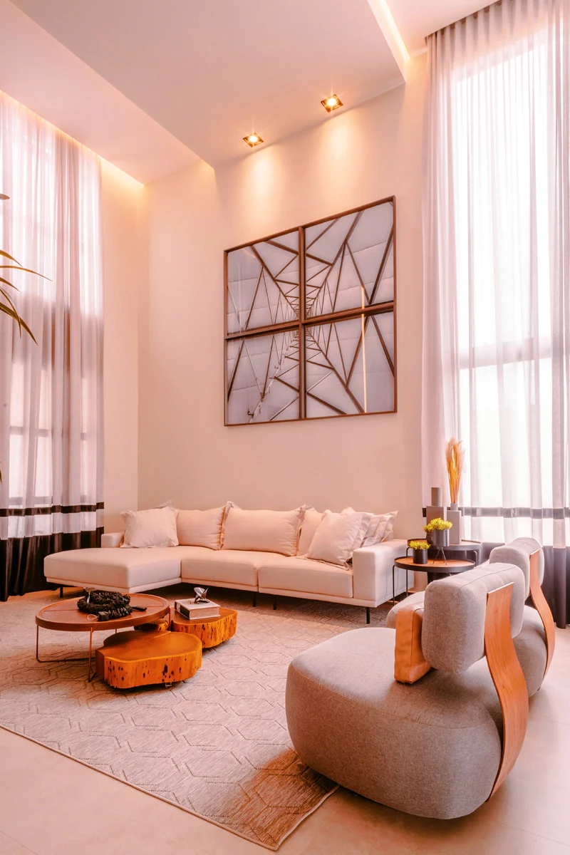 Spacious living room with high ceiling and long curtains