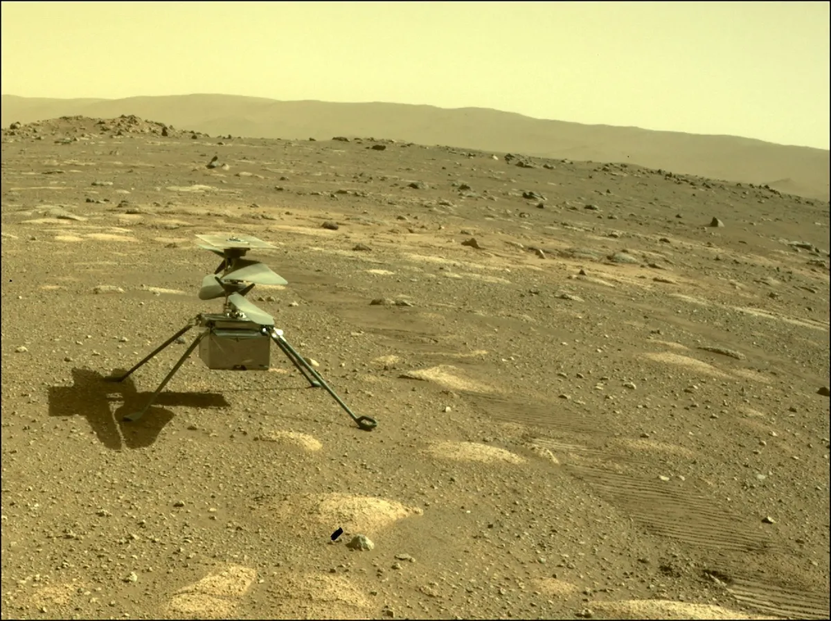 T-Minus: Countdown to the 10 best space stories of 2024 4 A small robotic helicopter sits on dusty, rocky ground under a pale Martian sky. There are hills visible in the background.