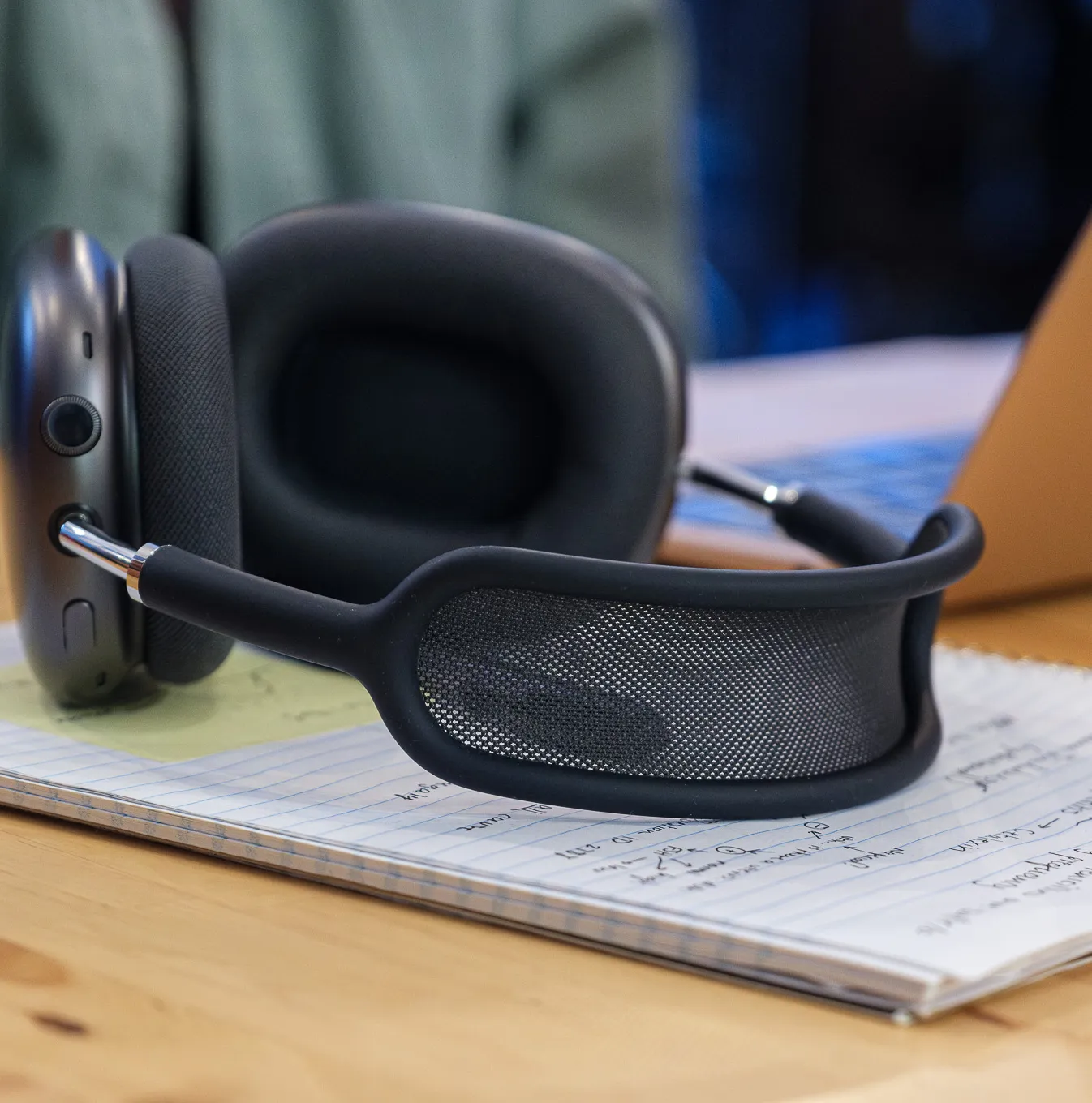 A photo of Apple's AirPods Max on a coffee shop table.
