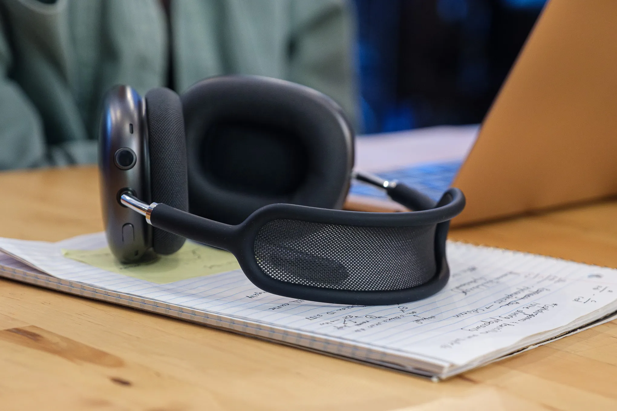 A photo of Apple's AirPods Max on a coffee shop table.