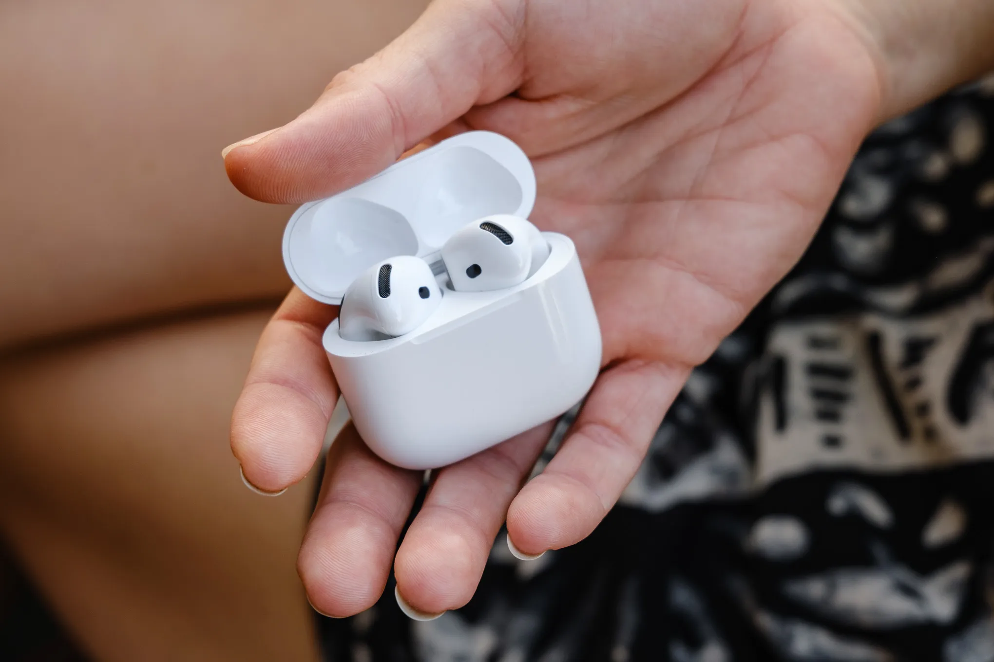A hands-on photo of Apple's AirPods 4 wireless earbuds.